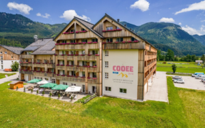 COOEE alpin Hotel Dachstein from the outside with a view of the sun terrace.