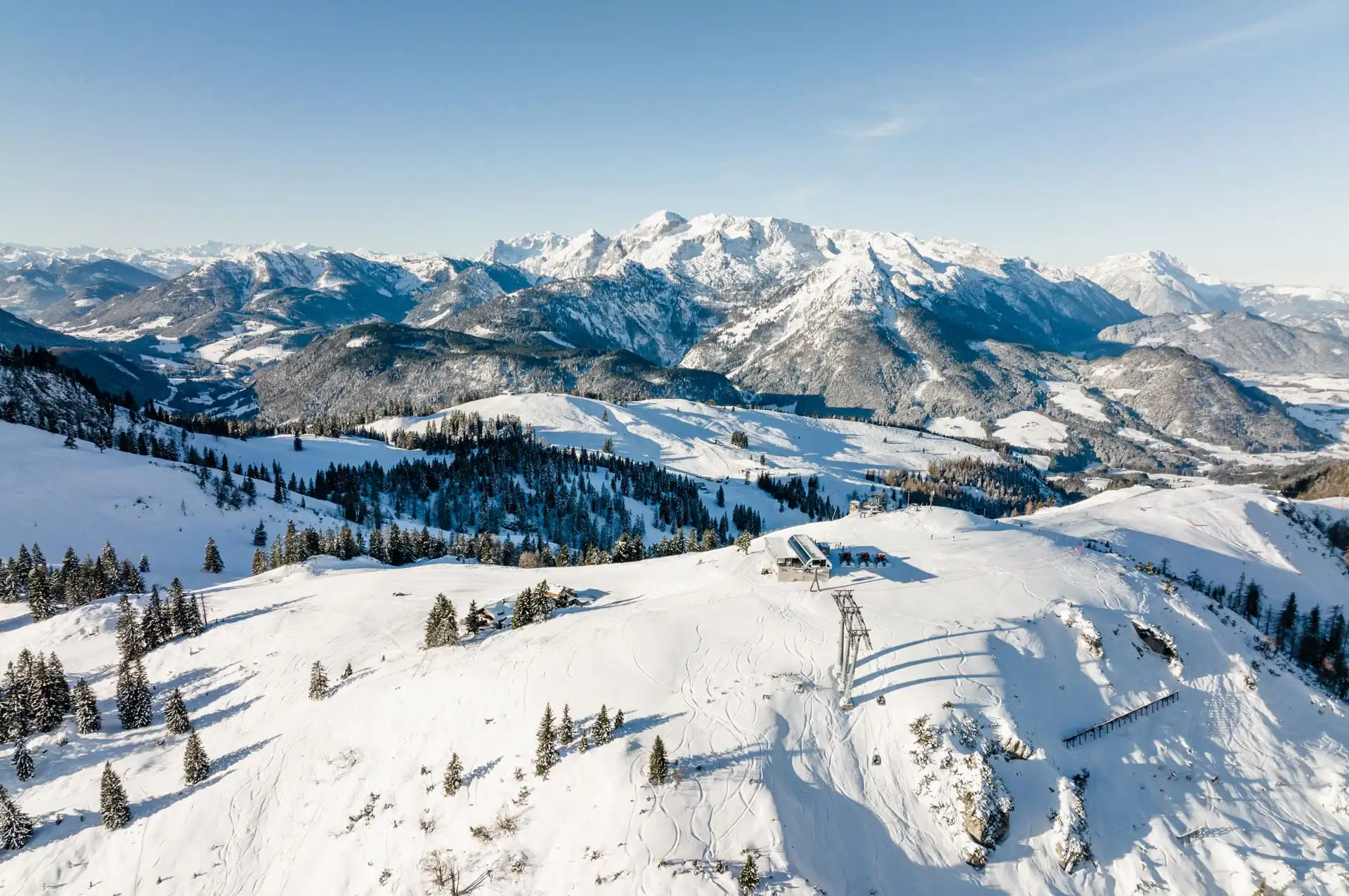 Atemberaubende Luftaufnahme des Skigebiets Dachstein West in Gosau – verschneite Pisten, klare Sicht und beeindruckendes Alpenpanorama für einen unvergesslichen Winterurlaub.
